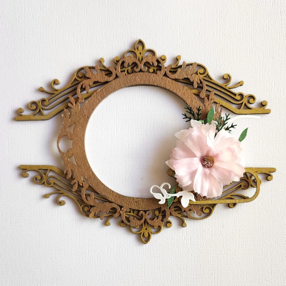 Ornate Circle Frame with Iron Flourish and Pink Blossom